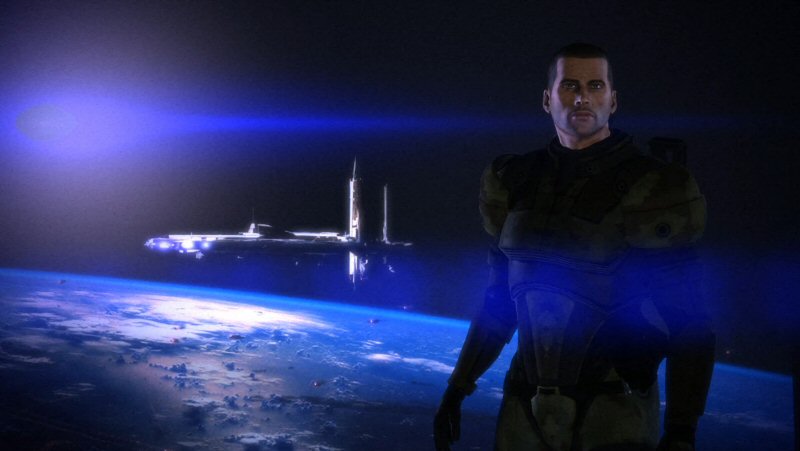 Just before the credits, Mass Effect 1 shows Shepard in front a planetary backdrop. There are explosions in the atmosphere, a lens-flare blue sun, and an unidentified space station / ship in the background. It's not Earth. I wonder where this is supposed to be and what it was supposed to mean.